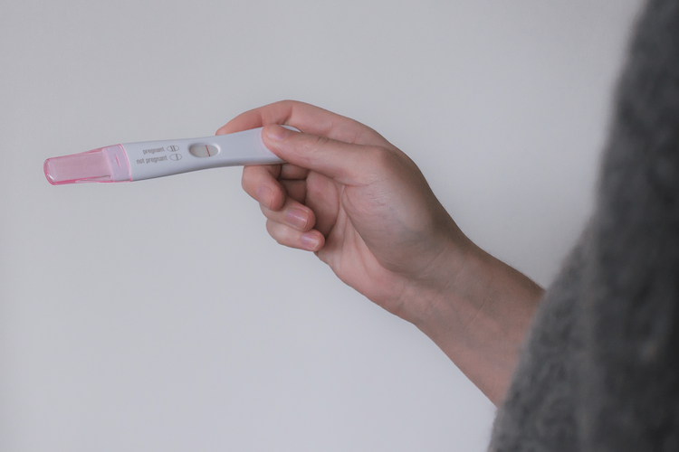 fertility-preperation-nutrition woman holding negative pregnancy test